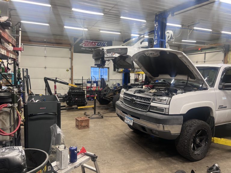Duramax Diesel Engine 1 Duramax diesel engine repair at Midwest Diesel & Automotive in Hammond, WI: a white Chevy pickup on the lift