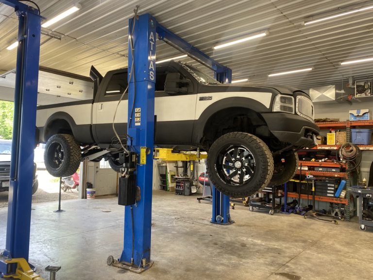 Diesel Losing Power Under Load? 6 Common Causes and How a Shop Finds Them 2 Lifted Ford diesel pickup on the lift for a diesel losing power under load diagnosis in Hammond, WI